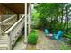 Backyard featuring stone patio with seating area and lush greenery, ideal for outdoor gatherings at 3423 Mulberry Lane Ct, Dacula, GA 30019