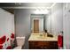Well-lit bathroom featuring vanity, updated fixtures, and decorative shower curtain at 3423 Mulberry Lane Ct, Dacula, GA 30019