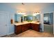 Bathroom vanity with double sinks, tile floors, and large mirror at 3423 Mulberry Lane Ct, Dacula, GA 30019