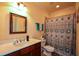 A functional bathroom featuring a toilet, tub with shower, single sink, and framed mirror at 3423 Mulberry Lane Ct, Dacula, GA 30019