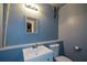 Blue tiled bathroom with updated sink vanity, toilet, and medicine cabinet at 3423 Mulberry Lane Ct, Dacula, GA 30019