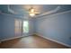 Bedroom with shutters, carpet, and ceiling fan at 3423 Mulberry Lane Ct, Dacula, GA 30019