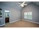 Bedroom with ceiling fan and a bathroom through the door at 3423 Mulberry Lane Ct, Dacula, GA 30019