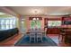 Hardwood floors lead from a dining room with modern light fixtures to the well-appointed kitchen and living spaces at 3423 Mulberry Lane Ct, Dacula, GA 30019