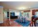 A dining room opens to the living room, showcasing hardwood floors and a chandelier at 3423 Mulberry Lane Ct, Dacula, GA 30019
