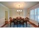 Elegant dining room featuring hardwood floors, natural light, and stylish chandelier at 3423 Mulberry Lane Ct, Dacula, GA 30019
