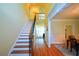 Spacious foyer with hardwood floors, staircase and view into other rooms at 3423 Mulberry Lane Ct, Dacula, GA 30019