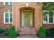 Inviting front entrance featuring a wreath-adorned door and meticulously maintained landscaping at 3423 Mulberry Lane Ct, Dacula, GA 30019