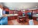 Spacious kitchen with island, granite counters, cherry cabinets, and stainless steel appliances at 3423 Mulberry Lane Ct, Dacula, GA 30019