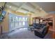 An open living room with a decorative ceiling, stone fireplace, built-in shelving and an attached kitchen at 3423 Mulberry Lane Ct, Dacula, GA 30019