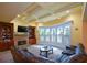 This bright living room includes a stone fireplace, built-in shelving, and large windows at 3423 Mulberry Lane Ct, Dacula, GA 30019