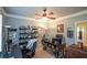 Functional home office featuring ample shelving, a ceiling fan and natural light at 3423 Mulberry Lane Ct, Dacula, GA 30019