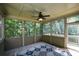 Cozy screened porch showcasing wood flooring, paneled ceiling, and views of the surrounding trees at 3423 Mulberry Lane Ct, Dacula, GA 30019