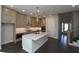 Modern kitchen with sleek countertops, stainless steel appliances, pendant lighting, and dark hardwood flooring at 4435 Beechnut Cir, Cumming, GA 30028