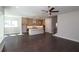 Open concept living space showcasing hardwood floors, neutral walls, and a modern kitchen with a large island at 4435 Beechnut Cir, Cumming, GA 30028