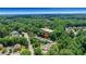 Aerial view of a residential community nestled amongst trees, marked with a red arrow indicating the property at 659 Holcomb Bridge Rd, Norcross, GA 30071