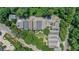Aerial view showcases the community's layout surrounded by lush greenery with parking and green space at 659 Holcomb Bridge Rd, Norcross, GA 30071