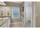 Bright bathroom featuring granite countertops, a glass-enclosed shower, and ample natural light at 659 Holcomb Bridge Rd, Norcross, GA 30071