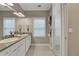 Well-lit bathroom featuring double sinks, granite countertops, a big mirror, and a glass-enclosed shower at 659 Holcomb Bridge Rd, Norcross, GA 30071
