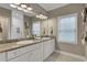 Well-lit bathroom with granite counters, double vanity, and a glass shower enclosure at 659 Holcomb Bridge Rd, Norcross, GA 30071