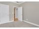 Neutral bedroom featuring a door leading to a staircase and an adjacent room at 659 Holcomb Bridge Rd, Norcross, GA 30071