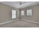 Bedroom boasting three large windows providing ample natural light and neutral carpeting at 659 Holcomb Bridge Rd, Norcross, GA 30071