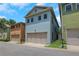 Multi-level townhome featuring double garage, neutral color palette, and lush green lawn on a sunny day at 659 Holcomb Bridge Rd, Norcross, GA 30071