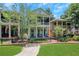Charming two-story home featuring a double front porch and a well-manicured lawn with black metal fence at 659 Holcomb Bridge Rd, Norcross, GA 30071