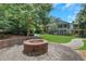 Well-manicured front yard featuring a decorative fire pit, lush lawn, and charming walkway leading to the homes at 659 Holcomb Bridge Rd, Norcross, GA 30071