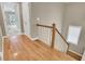 Bright hallway with gleaming hardwood floors and staircase leading to the next level at 659 Holcomb Bridge Rd, Norcross, GA 30071