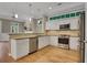 Open concept kitchen featuring stainless appliances, granite counters, and connection to living area at 659 Holcomb Bridge Rd, Norcross, GA 30071