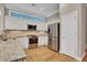 A chef's kitchen featuring stainless steel appliances and granite countertops at 659 Holcomb Bridge Rd, Norcross, GA 30071