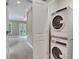 Laundry area with stacked washer and dryer appliances with view to an adjacent room at 659 Holcomb Bridge Rd, Norcross, GA 30071