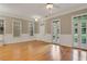 Spacious living room with hardwood floors, a double door to the backyard and large windows at 659 Holcomb Bridge Rd, Norcross, GA 30071