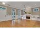 Spacious and bright living room with hardwood floors, a fireplace, and double doors leading to outdoor space at 659 Holcomb Bridge Rd, Norcross, GA 30071