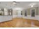Bright living room with hardwood floors, with open floor plan, modern lighting, and large windows at 659 Holcomb Bridge Rd, Norcross, GA 30071
