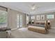 Spacious main bedroom featuring plush carpeting, ceiling fan, and double doors to a balcony at 659 Holcomb Bridge Rd, Norcross, GA 30071