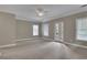 Carpeted main bedroom with crown molding, neutral walls, and double doors to a balcony at 659 Holcomb Bridge Rd, Norcross, GA 30071