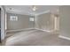 Large bedroom with a ceiling fan, two windows, and a door leading to the hallway at 659 Holcomb Bridge Rd, Norcross, GA 30071