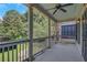 Charming porch with columns, a ceiling fan, and string lights overlooking lush greenery at 659 Holcomb Bridge Rd, Norcross, GA 30071