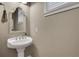 Cozy powder room with pedestal sink, mirror and window at 659 Holcomb Bridge Rd, Norcross, GA 30071