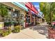 Charming storefronts with colorful awnings, outdoor seating, and vibrant floral arrangements line the street at 659 Holcomb Bridge Rd, Norcross, GA 30071