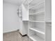 A carpeted walk-in closet with built-in shelving and drawers for organized storage at 659 Holcomb Bridge Rd, Norcross, GA 30071