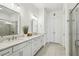 Modern bathroom featuring double sinks, stylish mirrors, and a glass shower at 115 Ivey Way, Woodstock, GA 30188