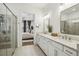 Bright bathroom with double sinks, modern fixtures, and glass enclosed shower at 115 Ivey Way, Woodstock, GA 30188