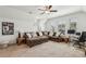 This large bonus room includes a ceiling fan, comfortable seating and a workspace at 115 Ivey Way, Woodstock, GA 30188