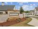 Entrance sign for Enclave at Wiley Bridge with brick and manicured landscaping at 115 Ivey Way, Woodstock, GA 30188