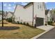 Charming home featuring manicured landscaping, dark trim and attached garage at 115 Ivey Way, Woodstock, GA 30188