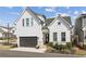 Charming two-story home featuring a black garage door, brick accents, and inviting front entrance at 115 Ivey Way, Woodstock, GA 30188