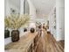 Hallway featuring stylish decor, hardwood floors, and ample natural light, leading to the living areas at 115 Ivey Way, Woodstock, GA 30188